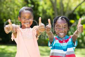 Young children doing thumbs up