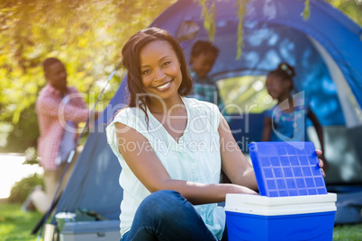 Happy woman posing and using a cooler