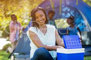 Happy woman posing and using a cooler