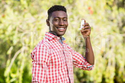 Happy man posing and holding an object