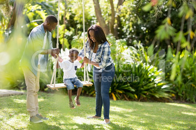 Happy family doing swing