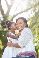 A daughter kissing her mother