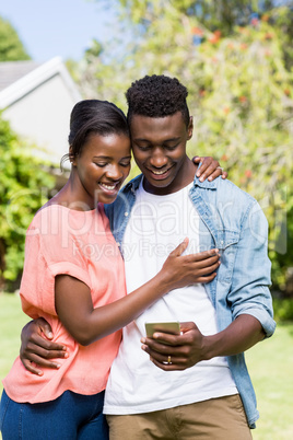 Happy couple looking their smartphone