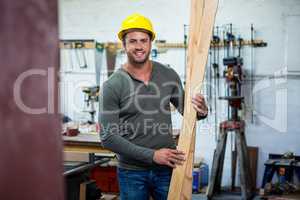 Carpenter is posing with his craft