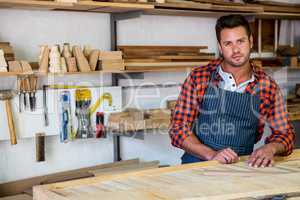 Carpenter posing with his craft