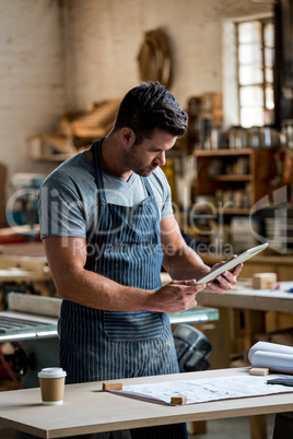 carpenter using his tablet