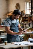 carpenter using his tablet