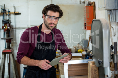 Carpenter is posing with his tablet