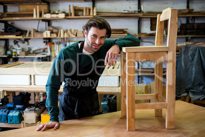 Carpenter is posing with his craft Carpenter is posing with his craft