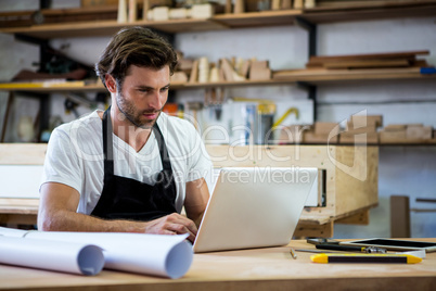 Carpenter is using his tablet