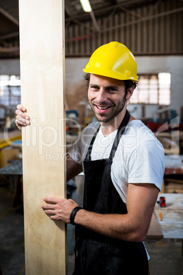 Carpenter is posing with his craft Carpenter is posing with his craft