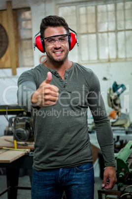 Carpenter is posing with thumbs up