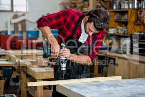 Carpenter using a drill