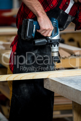 Carpenter using a drill