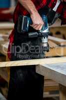 Carpenter using a drill