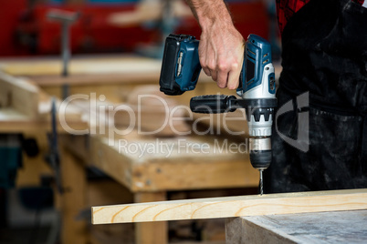 Carpenter using a drill