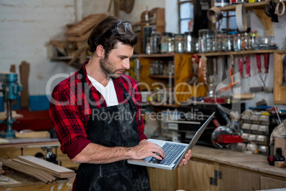 Carpenter working on his computer