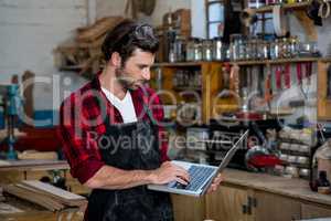 Carpenter working on his computer