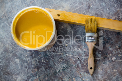 Image of tin of paint and paintbrush