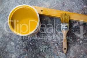 Image of tin of paint and paintbrush