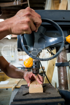 Carpenter using a drill