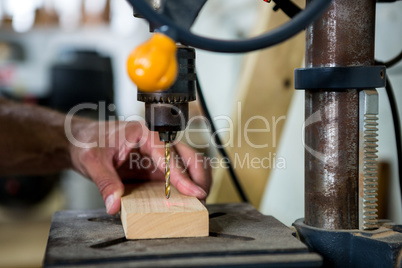 Carpenter using a drill