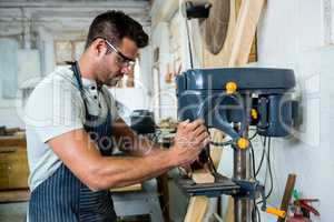 Carpenter using a drill