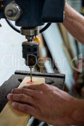Carpenter using a drill