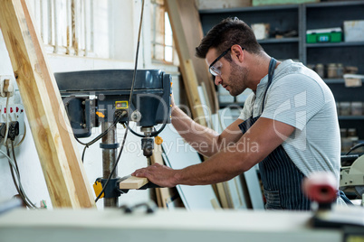 Carpenter using a drill