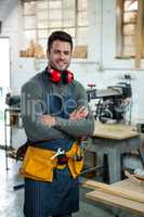 Carpenter smiling and crossing arms