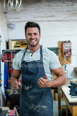 Carpenter smiling and throwing thumb