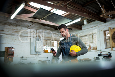 Carpenter using phone Carpenter using phone