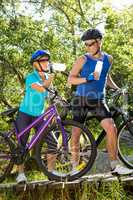 Senior couple standing with their bikes