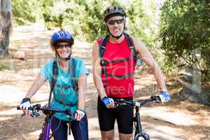 senior couple is smiling with their bike