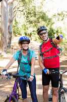 Senior couple standing with their bike