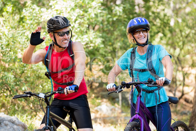 Senior couple standing with their bike