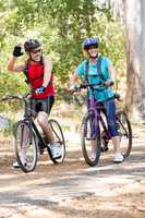 Senior couple standing with their bike