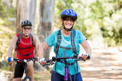 Senior couple standing with their bike