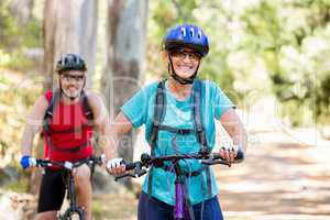 Senior couple standing with their bike