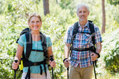 Senior couple standing with their stick