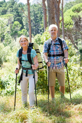 Senior couple standing with their stick