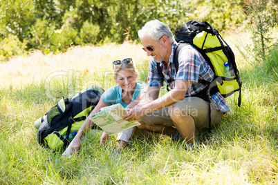 senior couple sitting in the grass