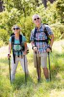 Senior couple standing with their stick