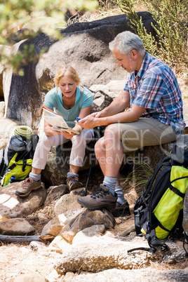 senior couple sitting on stones