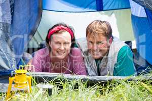 senior couple smiling inside their tent