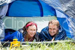 senior couple smiling inside their tent