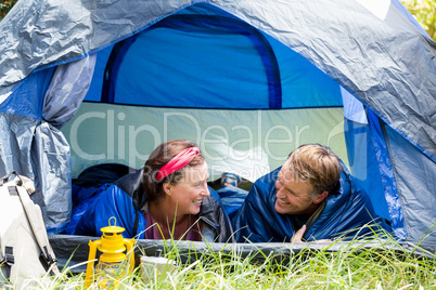 senior couple smiling inside their tent