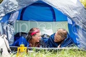 senior couple smiling inside their tent