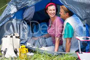 senior couple smiling inside their tent