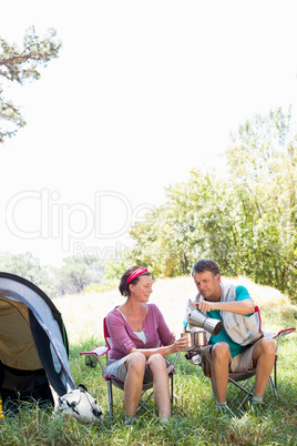 senior couple serving a cup of coffee